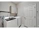 White front load washer and dryer with overhead cabinet in laundry room at 6127 Colmar Pl, Apollo Beach, FL 33572