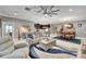 Open-concept living area showcases a comfortable seating area, adjacent to the dining area and modern kitchen at 6127 Colmar Pl, Apollo Beach, FL 33572