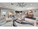 Open-concept living area showcases a comfortable seating area, adjacent to the dining area and modern kitchen at 6127 Colmar Pl, Apollo Beach, FL 33572