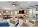 Spacious living room features a wood accent wall, fireplace, and open floor plan for seamless entertaining at 6127 Colmar Pl, Apollo Beach, FL 33572