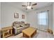 Cozy living room with a reclining sofa, wooden coffee table and ceiling fan at 6127 Colmar Pl, Apollo Beach, FL 33572