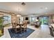 Open floor plan features living room, dining area and access to the outdoors at 6127 Colmar Pl, Apollo Beach, FL 33572