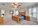 Main bedroom showcasing a ceiling fan, large bed, and coordinating furnishings at 6127 Colmar Pl, Apollo Beach, FL 33572
