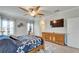 Well-lit main bedroom featuring a ceiling fan, dresser, and neutral walls at 6127 Colmar Pl, Apollo Beach, FL 33572