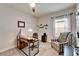 This home office has a desk, chair, a patterned chair, carpet floors, and a window with natural light at 6127 Colmar Pl, Apollo Beach, FL 33572