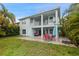 Expansive backyard featuring a patio, lush lawn, and tropical landscaping, ideal for outdoor living at 6416 Grenada Island Ave, Apollo Beach, FL 33572