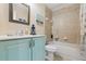 Bathroom features a vanity with light blue cabinets and a tub with shower at 6416 Grenada Island Ave, Apollo Beach, FL 33572