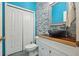 Stylish half-bathroom featuring a unique vessel sink, stone accent wall, and modern fixtures at 6416 Grenada Island Ave, Apollo Beach, FL 33572