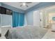 Cozy bedroom featuring a ceiling fan and access to an attached room at 6416 Grenada Island Ave, Apollo Beach, FL 33572