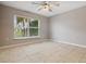 Empty bedroom with large window and tile floors at 6416 Grenada Island Ave, Apollo Beach, FL 33572