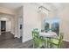 Cozy dining area with bright chairs, modern lighting, and access to a balcony with scenic views at 6416 Grenada Island Ave, Apollo Beach, FL 33572