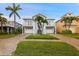Charming two-story coastal home with dual garages, balconies, palm trees, and well-manicured landscaping at 6416 Grenada Island Ave, Apollo Beach, FL 33572