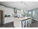 Bright, modern kitchen featuring stainless steel appliances, a spacious island with seating, and ample storage at 6416 Grenada Island Ave, Apollo Beach, FL 33572