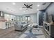 Open-concept living area showcasing a modern kitchen, stylish decor, and a comfortable gray sectional sofa at 6416 Grenada Island Ave, Apollo Beach, FL 33572