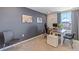 Home office with neutral carpet, dark gray accent wall, a large window and two side chairs at 6899 Broad River Ave, Land O Lakes, FL 34638