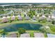 An aerial shot showcasing a home's backyard and serene pond views within a residential community at 6957 Boulder Run Loop, Wesley Chapel, FL 33545