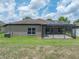 Exterior of home with a covered and screened in patio at 6957 Boulder Run Loop, Wesley Chapel, FL 33545