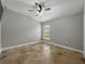 Bedroom featuring tile floors, ceiling fan with lighting and one window for natural light at 6957 Boulder Run Loop, Wesley Chapel, FL 33545