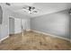 Spacious bedroom featuring a ceiling fan, tiled floors, and neutral paint, bathed in soft, natural light at 6957 Boulder Run Loop, Wesley Chapel, FL 33545
