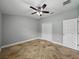Bedroom with a ceiling fan, tile floors, and closet with bi-fold doors at 6957 Boulder Run Loop, Wesley Chapel, FL 33545