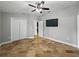 Bedroom featuring neutral walls, tile flooring, and a ceiling fan with lighting at 6957 Boulder Run Loop, Wesley Chapel, FL 33545