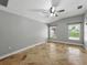 Large bedroom with tile floors, a ceiling fan, and windows providing lots of natural light at 6957 Boulder Run Loop, Wesley Chapel, FL 33545