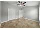 Bedroom featuring tile floors, ceiling fan with light, and closet with bi-fold doors at 6957 Boulder Run Loop, Wesley Chapel, FL 33545