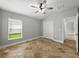 Bedroom featuring neutral paint, window, tile floors, and ceiling fan with lighting at 6957 Boulder Run Loop, Wesley Chapel, FL 33545