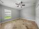 Bedroom featuring tile floors, a ceiling fan, and a large window at 6957 Boulder Run Loop, Wesley Chapel, FL 33545
