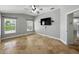 Bedroom with tiled floors, ceiling fan, and windows with backyard views at 6957 Boulder Run Loop, Wesley Chapel, FL 33545