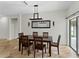Dining room featuring a wooden table, modern lighting, and neutral wall colors at 6957 Boulder Run Loop, Wesley Chapel, FL 33545