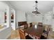 Dining room flowing into the living room and kitchen areas with natural light at 6957 Boulder Run Loop, Wesley Chapel, FL 33545