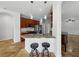 Kitchen featuring wooden cabinets, granite countertops, and barstool seating at 6957 Boulder Run Loop, Wesley Chapel, FL 33545