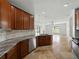 Kitchen features stainless appliances, granite counters, and a view into the adjacent living area at 6957 Boulder Run Loop, Wesley Chapel, FL 33545