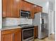 An expansive kitchen area boasts stainless steel appliances and beautiful wooden cabinetry at 6957 Boulder Run Loop, Wesley Chapel, FL 33545