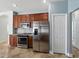 Kitchen with stainless steel appliances, granite countertops, and ample cabinet space at 6957 Boulder Run Loop, Wesley Chapel, FL 33545