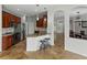 An open-concept kitchen with granite counters, stainless appliances, and a breakfast bar at 6957 Boulder Run Loop, Wesley Chapel, FL 33545