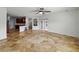 Spacious living room features tile flooring, ceiling fan, and open floor plan at 6957 Boulder Run Loop, Wesley Chapel, FL 33545