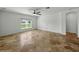 Large living room with neutral walls, and a window at 6957 Boulder Run Loop, Wesley Chapel, FL 33545