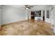 Spacious living room featuring tile flooring and an open layout leading to the kitchen at 6957 Boulder Run Loop, Wesley Chapel, FL 33545