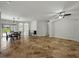 Spacious living room with travertine floors, arched doorways, and a view of the backyard at 6957 Boulder Run Loop, Wesley Chapel, FL 33545