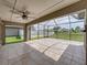 Large screened patio featuring a ceiling fan and tile flooring at 6957 Boulder Run Loop, Wesley Chapel, FL 33545
