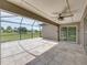 Covered tile patio with ceiling fan offering views of the fenced in backyard at 6957 Boulder Run Loop, Wesley Chapel, FL 33545