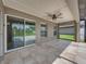 Covered tile patio with ceiling fan at 6957 Boulder Run Loop, Wesley Chapel, FL 33545