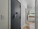 Hallway featuring a secure safe room door offering enhanced protection and security with combination lock at 6957 Boulder Run Loop, Wesley Chapel, FL 33545