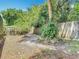 A wooded backyard with a privacy fence at 7613 Bramblewood Dr, Port Richey, FL 34668