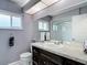 Bathroom with vanity, granite countertop, and framed mirror at 7613 Bramblewood Dr, Port Richey, FL 34668