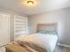 Bedroom featuring a closet, a decorative shelf and a queen bed at 7613 Bramblewood Dr, Port Richey, FL 34668
