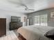 Bedroom featuring a ceiling fan, tiled floor, dresser, and sliding glass doors to the pool area at 7613 Bramblewood Dr, Port Richey, FL 34668