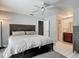 Bedroom with a ceiling fan, tiled floor, and ensuite bathroom at 7613 Bramblewood Dr, Port Richey, FL 34668